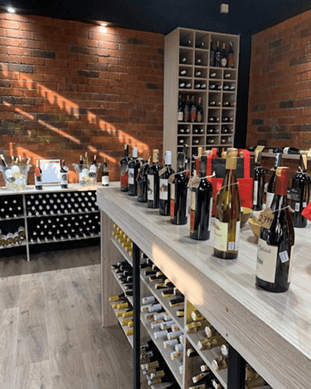 Rose holding wine bottle in wine shop