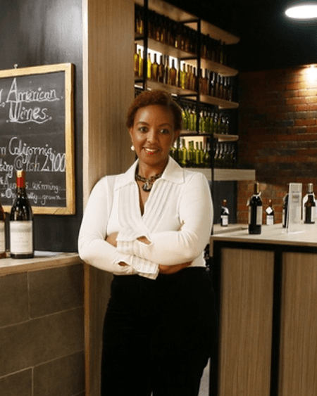 Rose holding wine bottle in wine shop